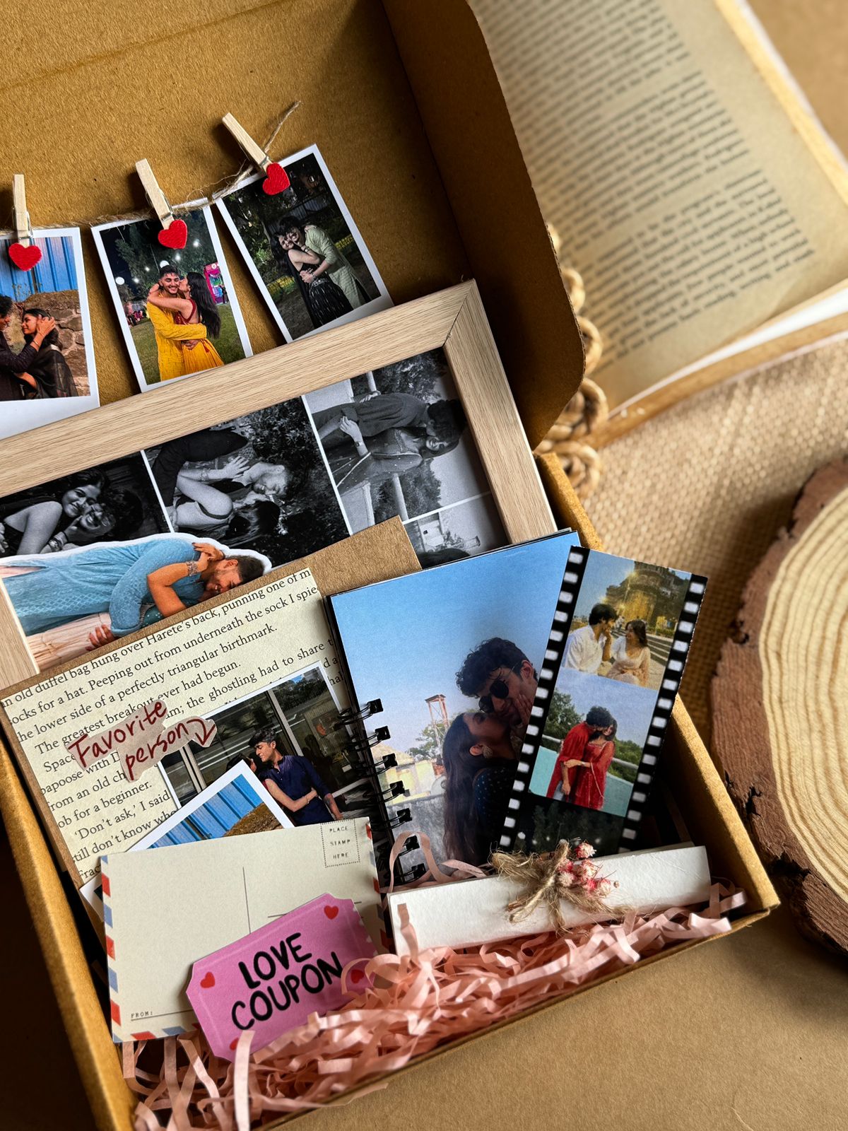 Best Valentine’s Combo handmade gift hamper with photo strip, photo book, polaroid, mini letter, frame, and hanging photos arranged in a decorative box.