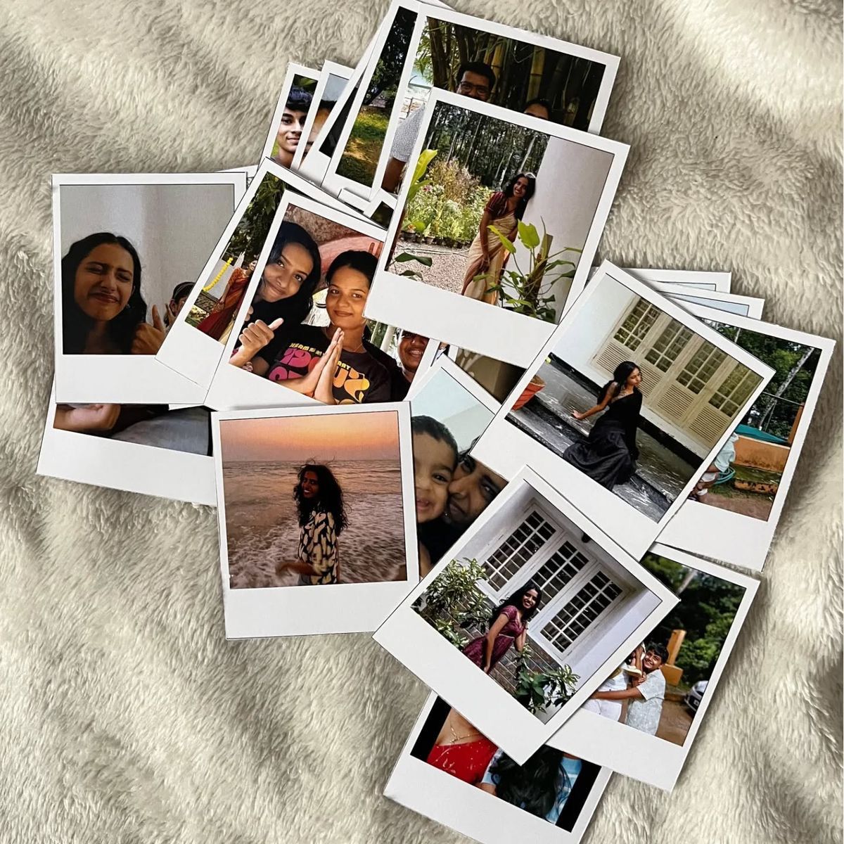 Small polaroid photo prints (7.5x6 cm) arranged on fabric, perfect for gifting and keepsakes.