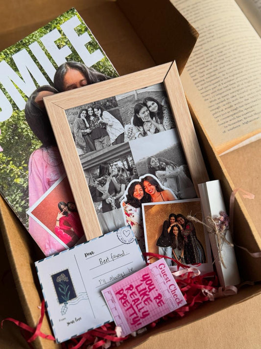 Personalized scrapbook-style keepsake hamper featuring polaroids, postcards, and decorative stickers